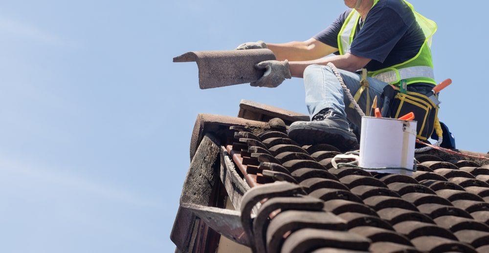 Roofer installing tile